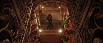 Movie still from “What's Love Got to Do with It?” (2022), directed by Shekhar Kapur – A woman sitting on the steps of a building; Extreme Wide shot, Overhead angle