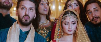 Movie still from “What's Love Got to Do with It?” (2022), directed by Shekhar Kapur – A man and two women in traditional indian clothing; Close Up shot, Over the shoulder angle