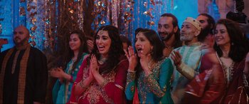 Movie still from “What's Love Got to Do with It?” (2022), directed by Shekhar Kapur – A group of people standing next to each other; Medium shot, Over the shoulder angle