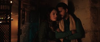 Movie still from “What's Love Got to Do with It?” (2022), directed by Shekhar Kapur – A man and a woman standing next to each other in the dark; Close Up shot, Low angle