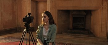 Movie still from “What's Love Got to Do with It?” (2022), directed by Shekhar Kapur – A woman sitting in front of a fire place; Medium shot, Over the shoulder angle