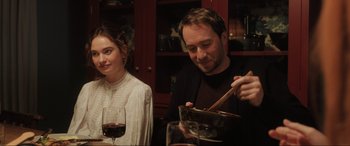 Movie still from “What's Love Got to Do with It?” (2022), directed by Shekhar Kapur – A man and a woman sitting in front of a bowl of food; Medium shot, Over the shoulder angle