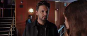 Movie still from “What's Love Got to Do with It?” (2022), directed by Shekhar Kapur – A person wearing a jacket; Close Up shot, Over the shoulder angle