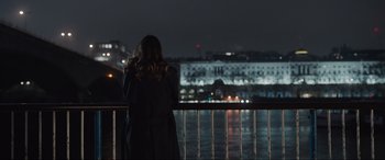 Movie still from “What's Love Got to Do with It?” (2022), directed by Shekhar Kapur – A woman standing on a bridge at night; Extreme Wide shot, Over the shoulder angle