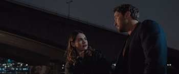 Movie still from “What's Love Got to Do with It?” (2022), directed by Shekhar Kapur – A man and a woman standing next to each other in front of a bridge; Close Up shot, Over the shoulder angle