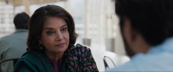 Movie still from “What's Love Got to Do with It?” (2022), directed by Shekhar Kapur – An older woman sitting in front of a man; Close Up shot, Over the shoulder angle