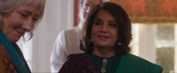 Movie still from “What's Love Got to Do with It?” (2022), directed by Shekhar Kapur – A woman in a green and purple dress and a man in a white shirt; Close Up shot, Over the shoulder angle