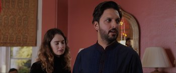 Movie still from “What's Love Got to Do with It?” (2022), directed by Shekhar Kapur – A man and a woman standing next to each other in a room; Close Up shot, Over the shoulder angle