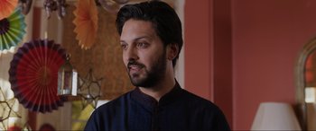 Movie still from “What's Love Got to Do with It?” (2022), directed by Shekhar Kapur – A person with a beard; Close Up shot, Over the shoulder angle