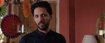 Movie still from “What's Love Got to Do with It?” (2022), directed by Shekhar Kapur – A person with a beard; Close Up shot, Over the shoulder angle