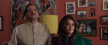 Movie still from “What's Love Got to Do with It?” (2022), directed by Shekhar Kapur – A man and a woman standing next to each other in a room; Medium shot, Low angle