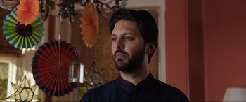 Movie still from “What's Love Got to Do with It?” (2022), directed by Shekhar Kapur – A person wearing a black shirt; Close Up shot, Low angle