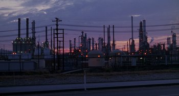 Movie still from “When Harry Met Sally...” (1989), directed by Rob Reiner – An oil refinery is lit up at dusk; Extreme Wide shot, Low angle