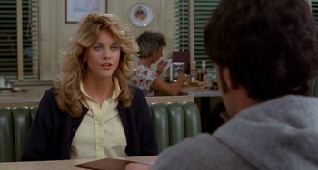 Movie still from “When Harry Met Sally...” (1989), directed by Rob Reiner – A woman sitting at a table in front of a man; Medium shot, Over the shoulder angle