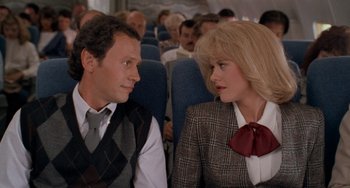 Movie still from “When Harry Met Sally...” (1989), directed by Rob Reiner – A man and a woman sitting next to each other on a plane; Medium shot, Over the shoulder angle