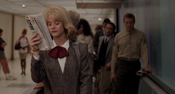 Movie still from “When Harry Met Sally...” (1989), directed by Rob Reiner – A woman in a suit and a red bow tie; Medium shot, Over the shoulder angle
