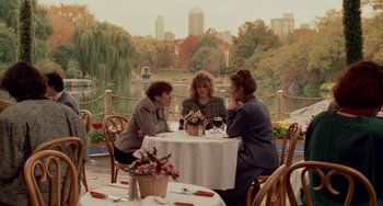Movie still from “When Harry Met Sally...” (1989), directed by Rob Reiner – A group of women sitting at a table with a city in the background; Wide shot, High angle