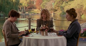 Movie still from “When Harry Met Sally...” (1989), directed by Rob Reiner – A woman sitting at a table with two men; Wide shot, Over the shoulder angle