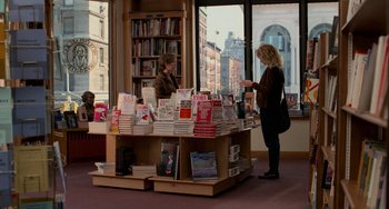 Movie still from “When Harry Met Sally...” (1989), directed by Rob Reiner – A woman standing in front of a table full of books; Wide shot, High angle
