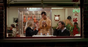 Movie still from “When Harry Met Sally...” (1989), directed by Rob Reiner – Three people sitting at a table in front of a window; Medium shot, Over the shoulder angle