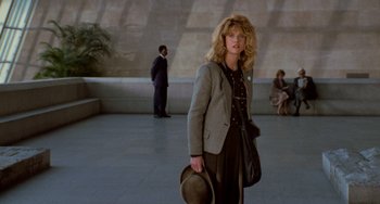 Movie still from “When Harry Met Sally...” (1989), directed by Rob Reiner – A woman in a hat and a jacket walking in a building; Wide shot, Low angle