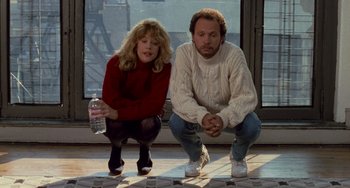 Movie still from “When Harry Met Sally...” (1989), directed by Rob Reiner – Two people squatting on the ground holding a water bottle; Medium shot, High angle