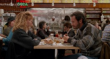 Movie still from “When Harry Met Sally...” (1989), directed by Rob Reiner – A group of people sitting at a table eating food; Medium shot, Over the shoulder angle