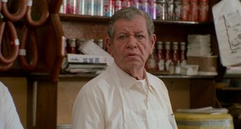 Movie still from “When Harry Met Sally...” (1989), directed by Rob Reiner – An older man wearing a white apron in a store; Close Up shot, Low angle