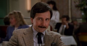 Movie still from “When Harry Met Sally...” (1989), directed by Rob Reiner – A person wearing a suit and tie; Close Up shot, Low angle