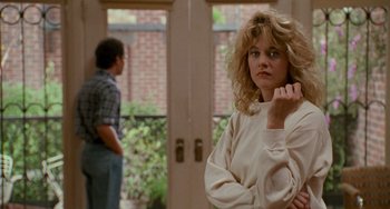 Movie still from “When Harry Met Sally...” (1989), directed by Rob Reiner – A woman standing in front of a man in a doorway; Medium shot, Over the shoulder angle