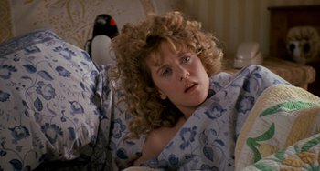 Movie still from “When Harry Met Sally...” (1989), directed by Rob Reiner – A woman laying in a bed under a blanket; Close Up shot, High angle