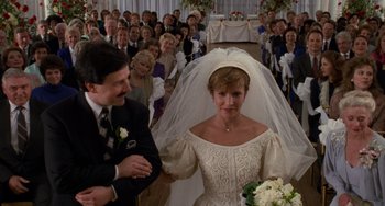 Movie still from “When Harry Met Sally...” (1989), directed by Rob Reiner – A woman in a white dress and a bouquet of white flowers in front of a crowd of people; Medium shot, High angle
