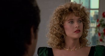 Movie still from “When Harry Met Sally...” (1989), directed by Rob Reiner – A person with curly hair wearing a necklace; Close Up shot, Over the shoulder angle