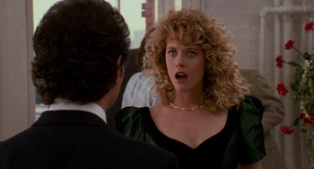 Movie still from “When Harry Met Sally...” (1989), directed by Rob Reiner – A woman with curly blonde hair talking to a man in a black suit; Close Up shot, Over the shoulder angle