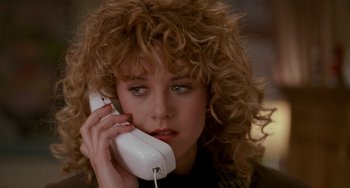 Movie still from “When Harry Met Sally...” (1989), directed by Rob Reiner – A woman with curly hair talking on a phone; Close Up shot, High angle