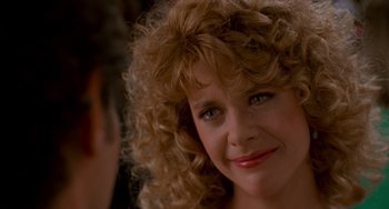 Movie still from “When Harry Met Sally...” (1989), directed by Rob Reiner – A person with curly blonde hair; Close Up shot, Over the shoulder angle