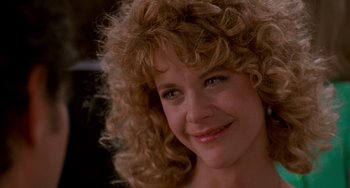 Movie still from “When Harry Met Sally...” (1989), directed by Rob Reiner – A person with curly blonde hair; Close Up shot, Over the shoulder angle