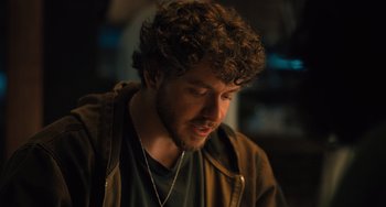 Movie still from “White Men Can't Jump” (2023), directed by Calmatic – A person wearing a jacket; Close Up shot, Over the shoulder angle