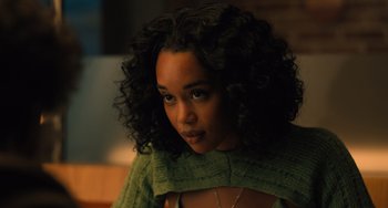 Movie still from “White Men Can't Jump” (2023), directed by Calmatic – A person wearing a green sweater; Close Up shot, Over the shoulder angle