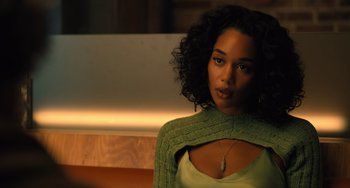 Movie still from “White Men Can't Jump” (2023), directed by Calmatic – A woman in a green sweater looking at the camera; Close Up shot, Over the shoulder angle