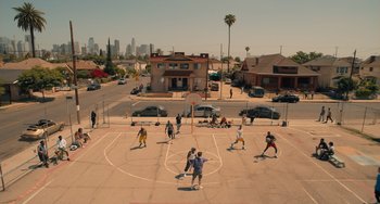 Movie still from “White Men Can't Jump” (2023), directed by Calmatic – A group of young people playing a game of basketball; Extreme Wide shot, High angle