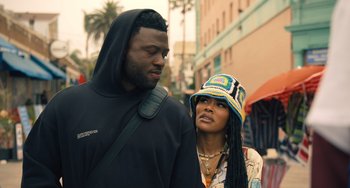 Movie still from “White Men Can't Jump” (2023), directed by Calmatic – A man and a woman standing next to each other on the street; Close Up shot, Over the shoulder angle