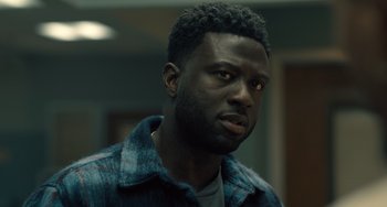 Movie still from “White Men Can't Jump” (2023), directed by Calmatic – A person wearing a blue shirt; Close Up shot, Low angle