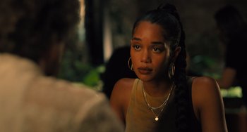 Movie still from “White Men Can't Jump” (2023), directed by Calmatic – A young woman with a ponytail and a necklace; Close Up shot, Over the shoulder angle