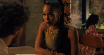 Movie still from “White Men Can't Jump” (2023), directed by Calmatic – A woman sitting at a table in a room; Close Up shot, Over the shoulder angle