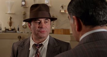 Movie still from “Who Framed Roger Rabbit” (1988), directed by Robert Zemeckis – A man in a suit and hat talking to another man in a suit; Close Up shot, Over the shoulder angle