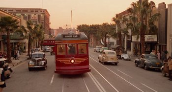Movie still from “Who Framed Roger Rabbit” (1988), directed by Robert Zemeckis – A red and black bus driving down a street; Extreme Wide shot, High angle