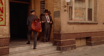 Movie still from “Who Framed Roger Rabbit” (1988), directed by Robert Zemeckis – Two men in suits and hats are walking down the steps; Wide shot, High angle