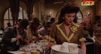 Movie still from “Who Framed Roger Rabbit” (1988), directed by Robert Zemeckis – A group of people sitting at a table with plates; Medium shot, Over the shoulder angle