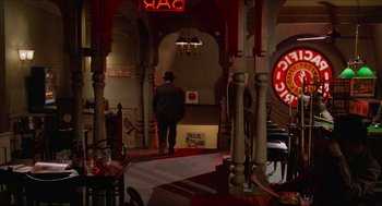 Movie still from “Who Framed Roger Rabbit” (1988), directed by Robert Zemeckis – A man in a hat is standing in a restaurant; Wide shot, High angle